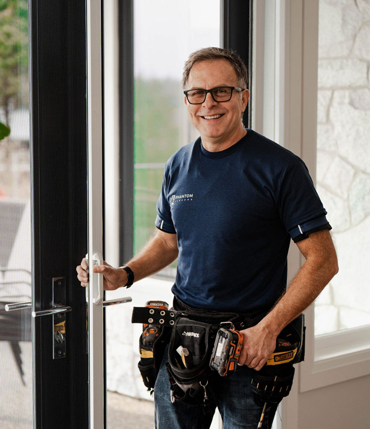 Phantom Screens technician installing retractable screen door